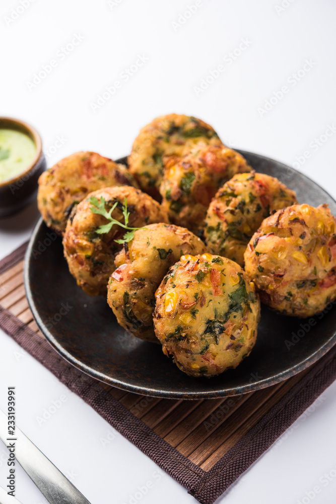 Crispy Corn Tikki, pakora/pakoda or pattice also known as cutlet. served with green chutney. Selective focus