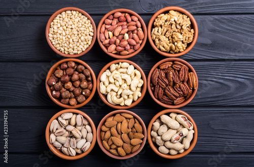 Mix of nuts : Pistachios, almonds , walnuts , pine nut , hazelnuts and cashew . Snack in bowl backgrond