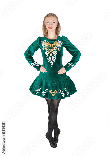 Beautiful young woman in Irish dance green dress isolated photo