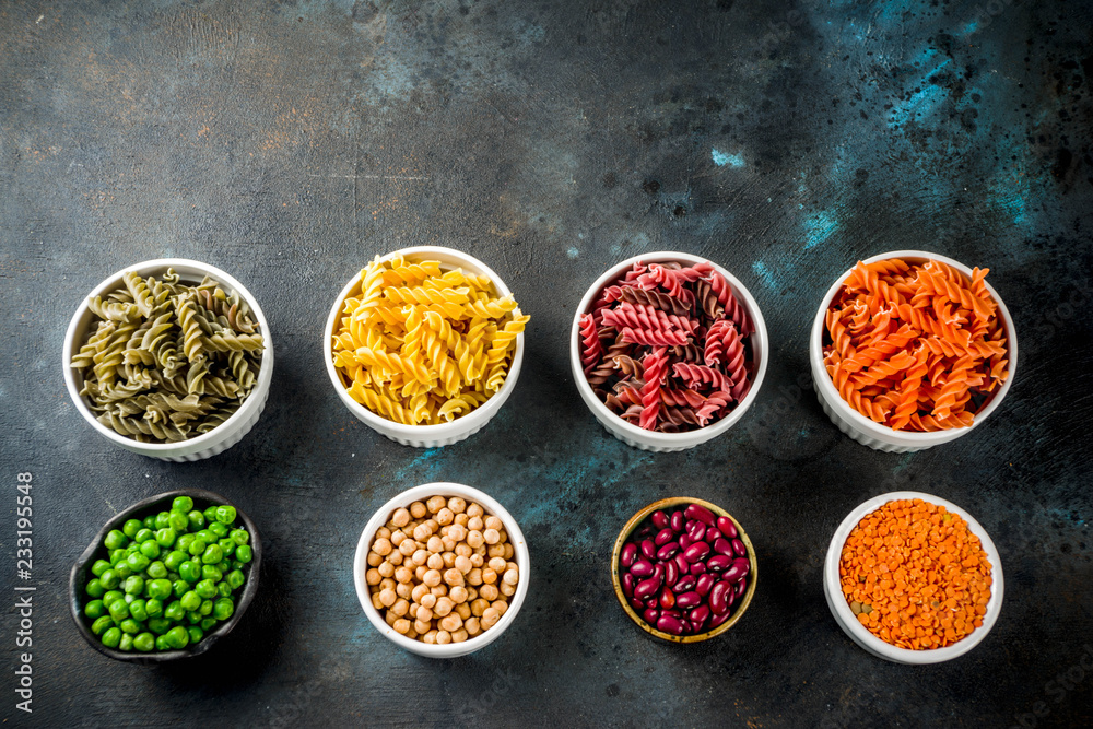 Trend healthy food, vegan diet concept. Multi colored legume pasta with raw beans. Beans, chickpeas, green peas, lentils. Copy space top view Trend healthy food, vegan diet concept. Multi colored legume pasta with raw beans. Beans, chickpeas, green peas, lentils. Copy space top view