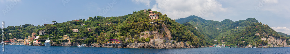 Panoramic view encompassing the entrance to Portofino harbour and the neighbouring town of Paraggi, Ligurian coast, Italy