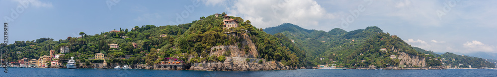 Panoramic view encompassing the entrance to Portofino harbour and the neighbouring town of Paraggi, Ligurian coast, Italy