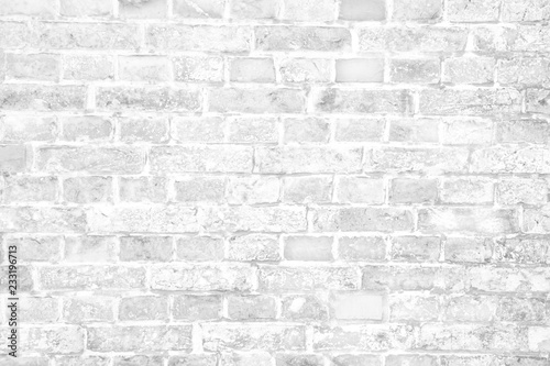 Simple grungy white brick wall with light and dark gray shades seamless pattern surface wall texture background.