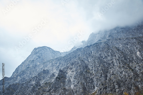 Dramatic Mountain Range With Stormy Clouds In The Sky - Blue Color
