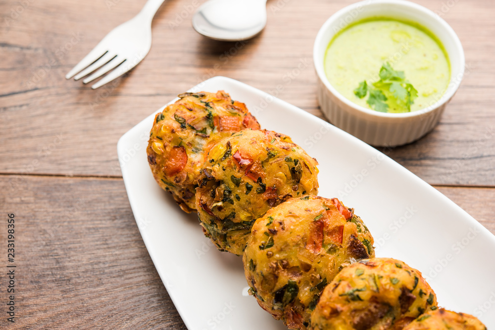 Crispy Corn Tikki, pakora/pakoda or pattice also known as cutlet. served with green chutney. Selective focus Crispy Corn Tikki, pakora/pakoda or pattice also known as cutlet. served with green chutney. Selective focus