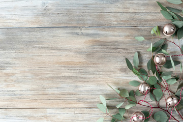 Christmas composition. X-mas card. New Year card. Winter holiday gift, eucalyptus and christmas balls on wooden background. Flat lay, top view, copy space