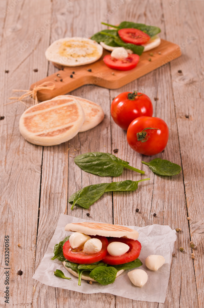 Tigella bread with spinach and tomatoes.