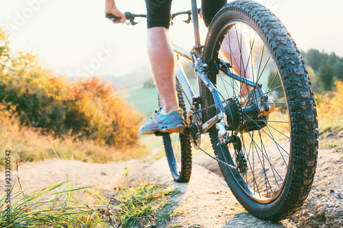 Mountain biker ride down from hill. Close up wheel image