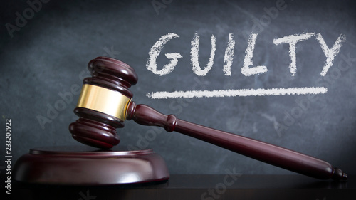 Photos Wooden hammer in a courthouse at verdict of GUILTY in a judgement