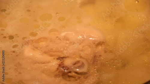 Drops of fat float on the surface of hot chicken bouillon
