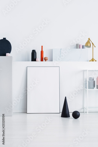 Black cone and ball on a white wall in a daily room interior