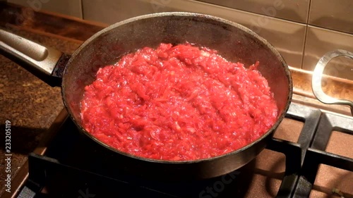 Filling for borscht is fried in a pan on the stove