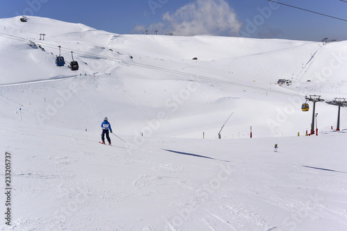 Skiers goes down  of the snowy mountains of Sierra Nevada