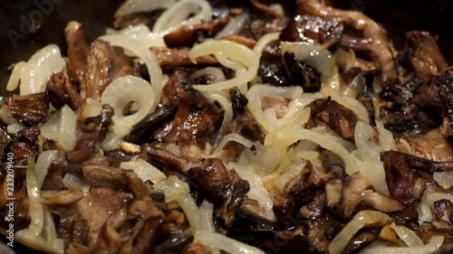 Honey agaric fried with onions in a pan