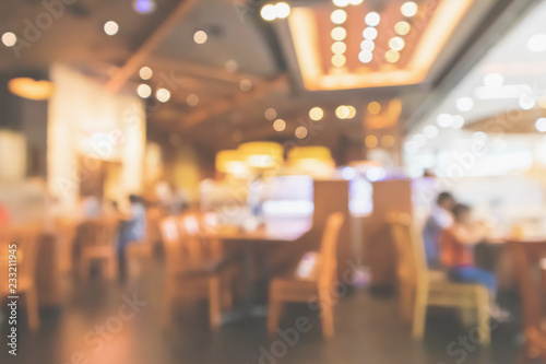 Restaurant interior with customer and wood table blur abstract background with bokeh light