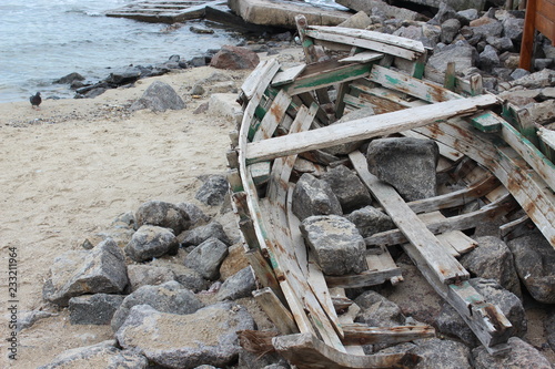 Broken wooden boat on the sea