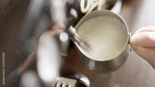 Female Barista Steaming a Mug of Hot Milk for a Latte. Espresso Coffee Preparation in Super Slow Motion