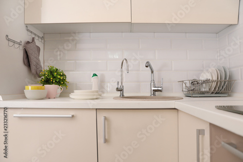 Clean dishes on counter near kitchen sink indoors