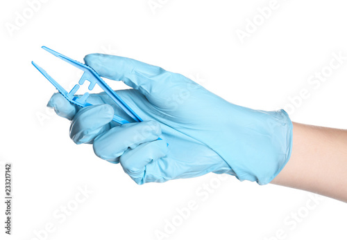 Doctor in medical glove holding disposable forceps on white background