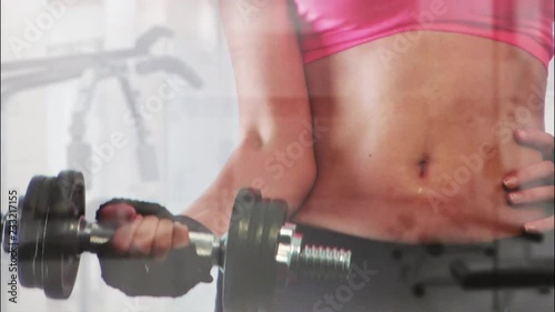 Fit woman lifting a dumbbell at the gym