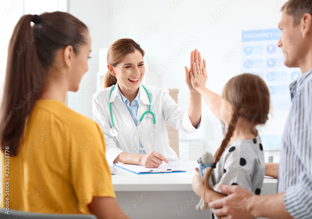 Parents with little daughter visiting children's doctor in hospital Parents with little daughter visiting children's doctor in hospital