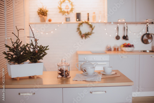 christmas kitchen interior tree decorated by lights gifts toys candles holiday concept