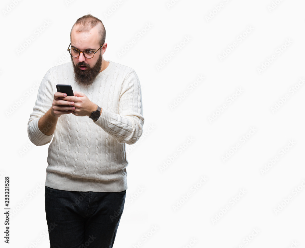 Young caucasian hipster man texting sending message using smartphone over isolated background scared in shock with a surprise face, afraid and excited with fear expression Young caucasian hipster man texting sending message using smartphone over isolated background scared in shock with a surprise face, afraid and excited with fear expression