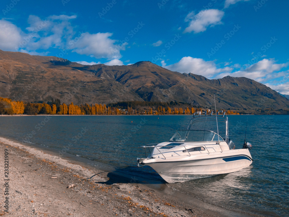 Single boat on Lake Wanaka at Roys Bay, Wanaka town, New Zealand