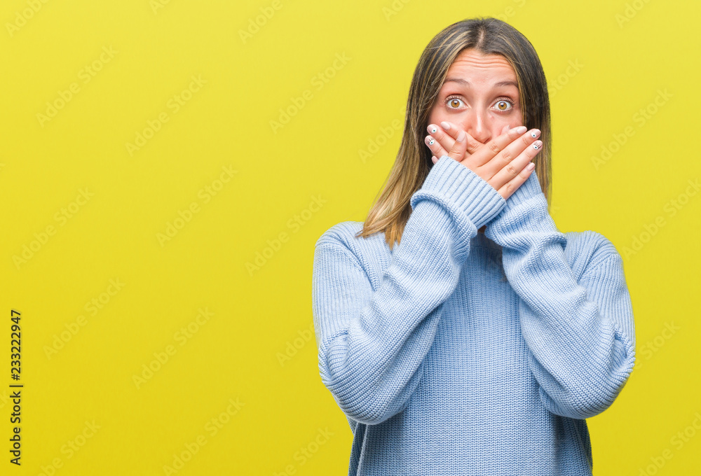 Young beautiful woman wearing winter sweater over isolated background shocked covering mouth with hands for mistake. Secret concept. Young beautiful woman wearing winter sweater over isolated background shocked covering mouth with hands for mistake. Secret concept.