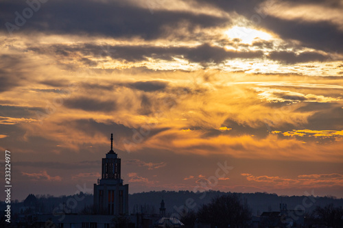 Skyline of church tower during sunset © Krzysztof