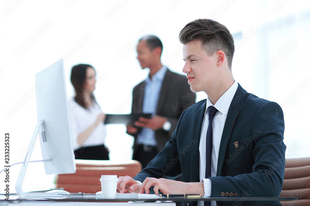 employee sitting behind a Desk in the office . employee sitting behind a Desk in the office .