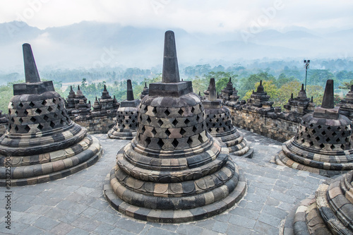 Sunrise among the stupas in Borobodur, a 9th-century Mahayana Buddhist complex in Magelang, Central Java, Indonesia photo