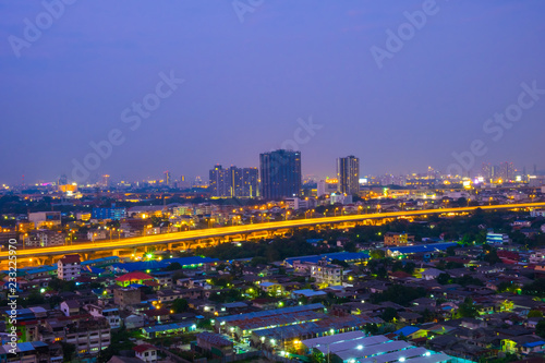 Cityscape from high rise building at night with skyline and clouds. skyscraper in metropolis town with beautiful neon light Bangkok Thailand.
