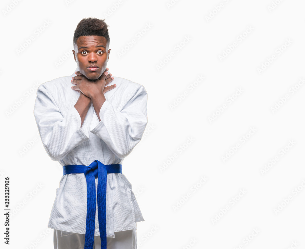 Young african american man over isolated background wearing kimono shouting and suffocate because painful strangle. Health problem. Asphyxiate and suicide concept. Young african american man over isolated background wearing kimono shouting and suffocate because painful strangle. Health problem. Asphyxiate and suicide concept.