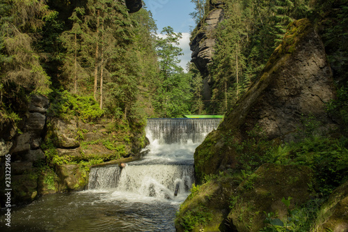 Bohemian Switzerland National Park. Landscape with mountain river with many rocks and pines. Czech Switzerland forest.
