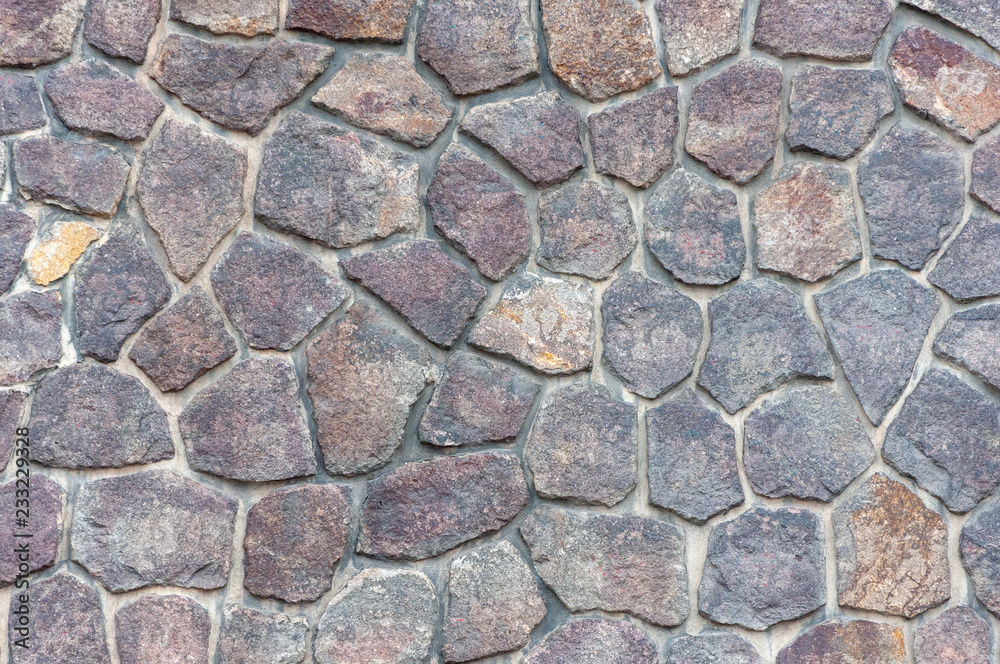 Fragment of masonry. The wall is made of natural stone. Background. Fragment of masonry. The wall is made of natural stone. Background.