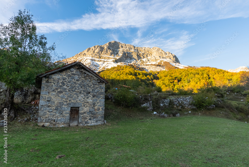 Old house in the middle of a valley at the foot of the mountain in the national park of Picos de Europa in the zone of Sajambre, Leon (Spain) used by the shepherds