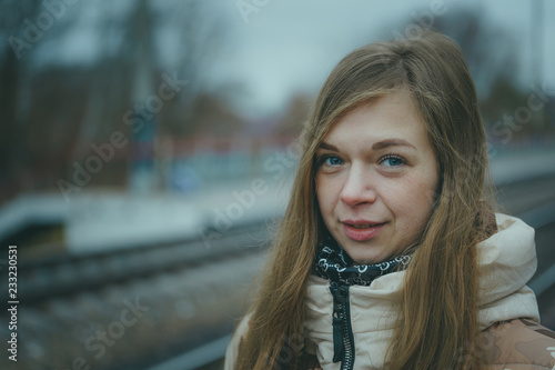 The girl on the railway track in cold weather. Nice girl on a railway road in an autumn day photo