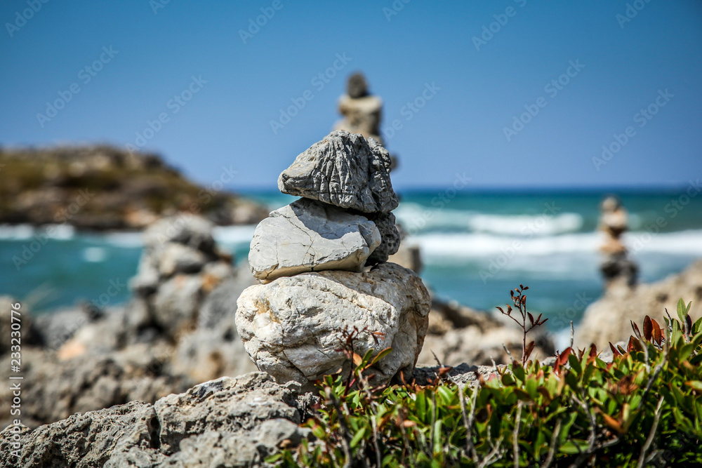 Pyramid of stones  on the sea and sky background