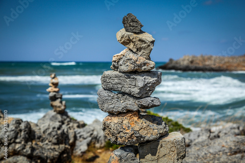 Pyramid of stones on the sea and sky background