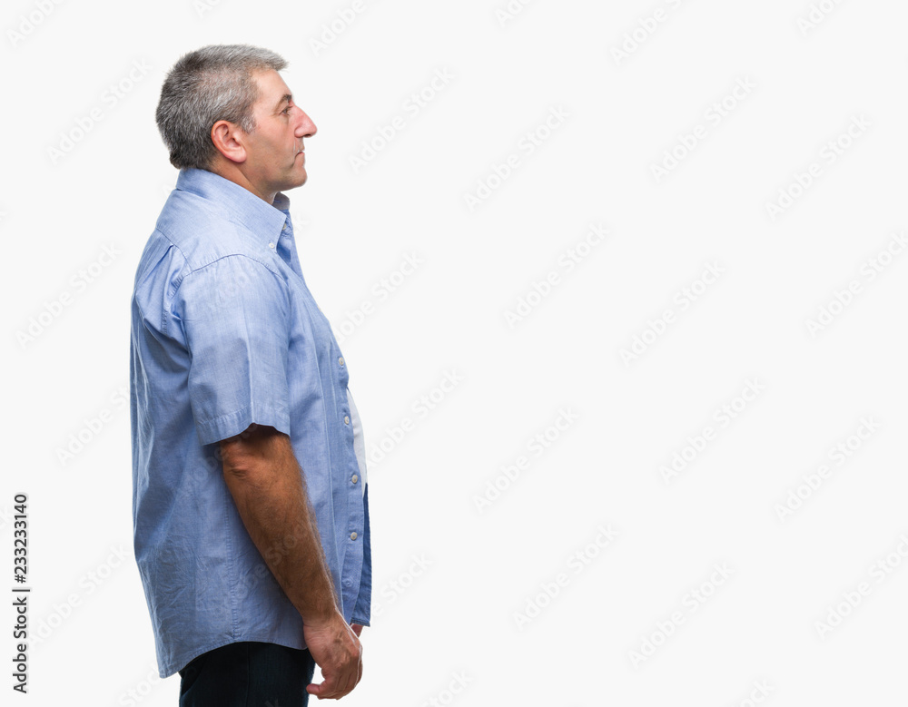 Fototapeta premium Handsome senior man over isolated background looking to side, relax profile pose with natural face with confident smile.