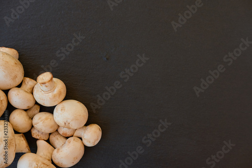 Champignon mushrooms on a black background