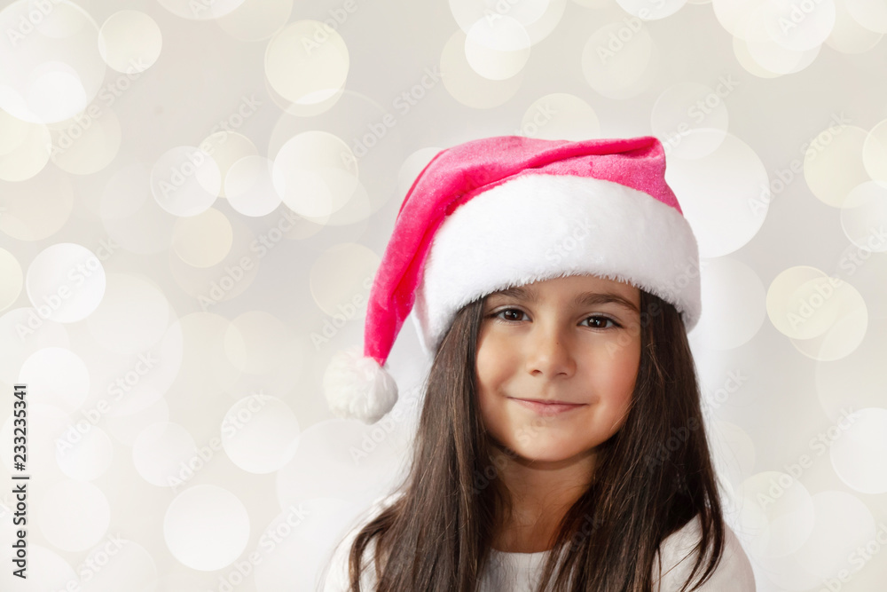 Christmas time - happy cheerful child girl in Santa Claus Hat Christmas time - happy cheerful child girl in Santa Claus Hat