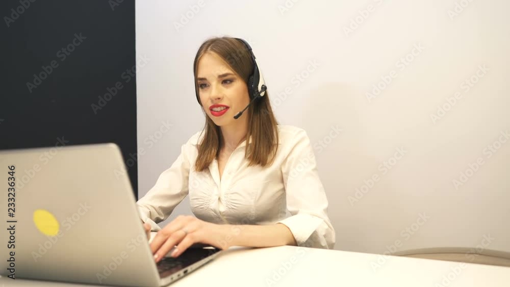 4K.Young woman operator work in customer support service center. Slider shot 4K.Young woman operator work in customer support service center. Slider shot