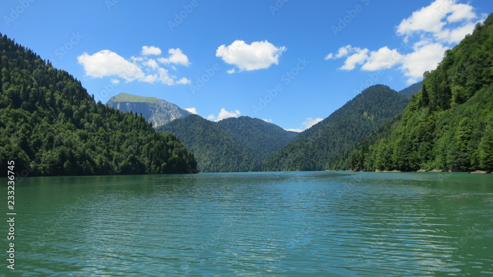 Fototapeta premium a lake among the mountains under blue sky with clouds