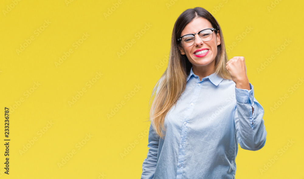 Young beautiful business woman wearing glasses over isolated background angry and mad raising fist frustrated and furious while shouting with anger. Rage and aggressive concept. Young beautiful business woman wearing glasses over isolated background angry and mad raising fist frustrated and furious while shouting with anger. Rage and aggressive concept.