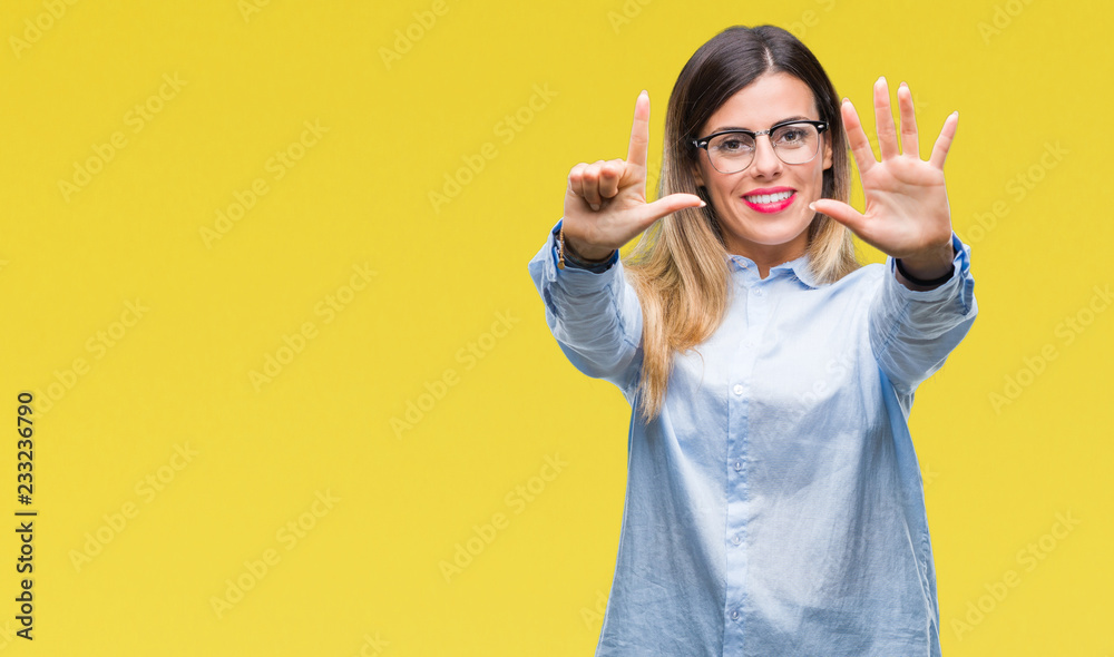 Fototapeta premium Young beautiful business woman wearing glasses over isolated background showing and pointing up with fingers number seven while smiling confident and happy.