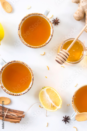 Tea with turmeric among products for improving immunity and treating colds - ginger, lemon, honey, anise. Top view, flat lay
