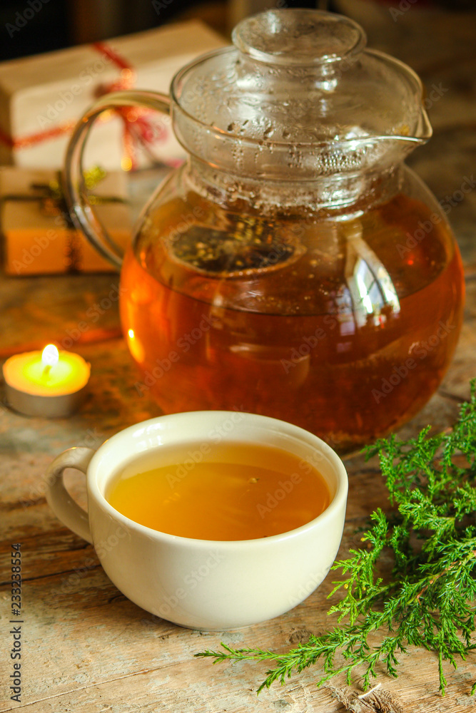 green tea in a transparent teapot on the table (herbal tea is brewed). top view. green tea in a transparent teapot on the table (herbal tea is brewed). top view.