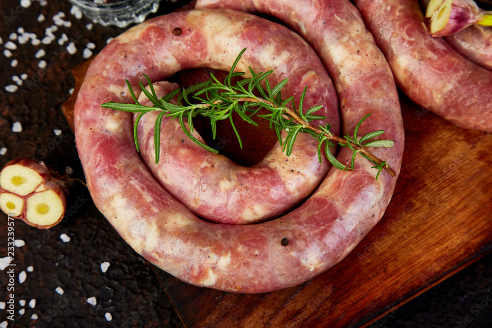 Raw spiral pork sausages with rosemary, salt and peper Raw spiral pork sausages with rosemary, salt and peper